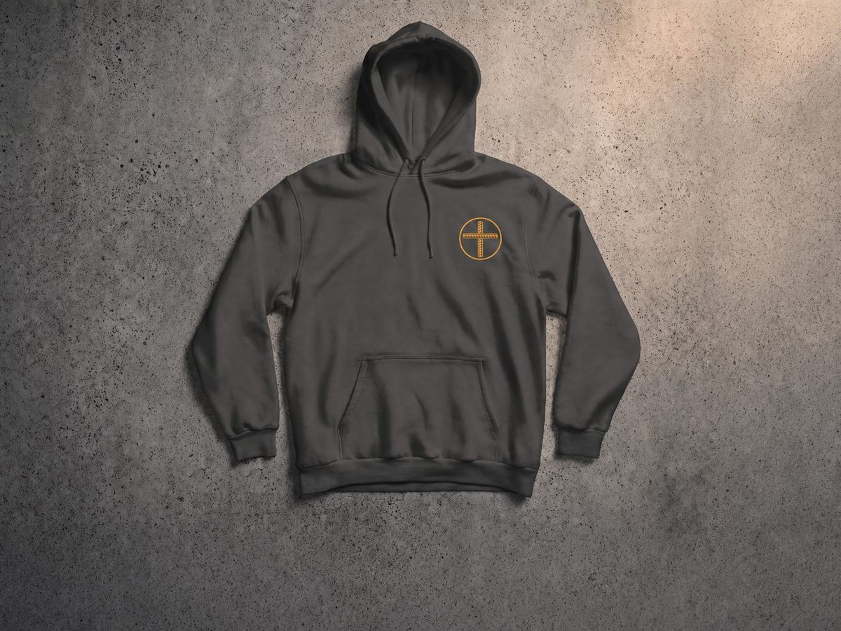 Charcoal-gray pullover hoodie with a small gold rebar-cross emblem on the chest